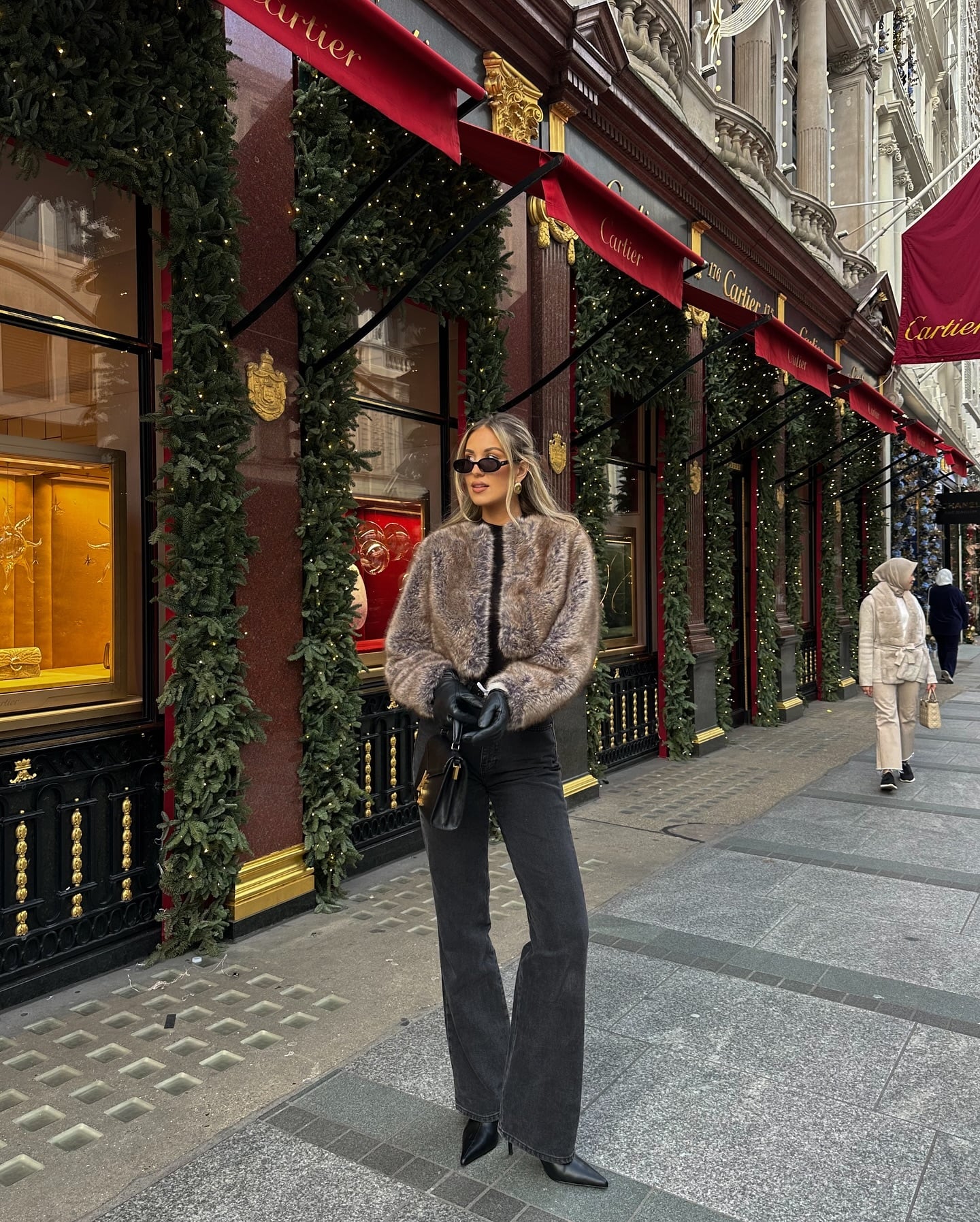 Dark wide-leg jeans with faux-fur jacket, leather gloves and pointed-toe boots for a casual winter dinner.