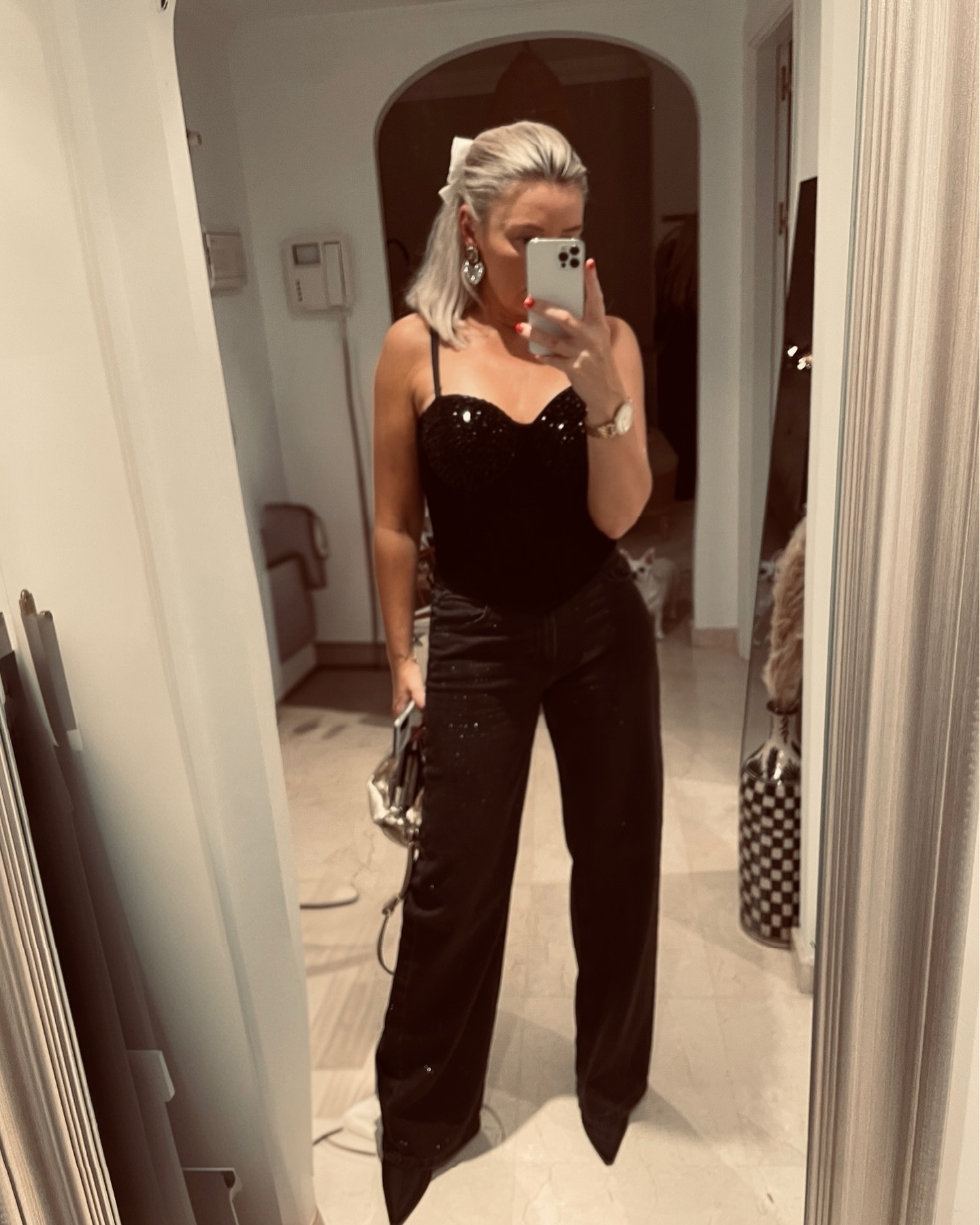 Black sequin corset top with tailored wide-leg black trousers for an elegant holiday dinner outfit.