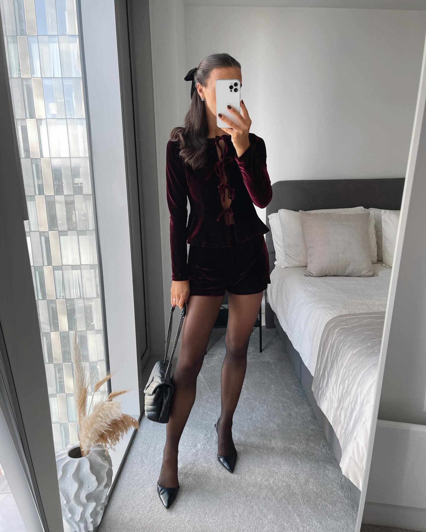 Burgundy velvet tie-front top with matching shorts for a festive Christmas Eve outfit.