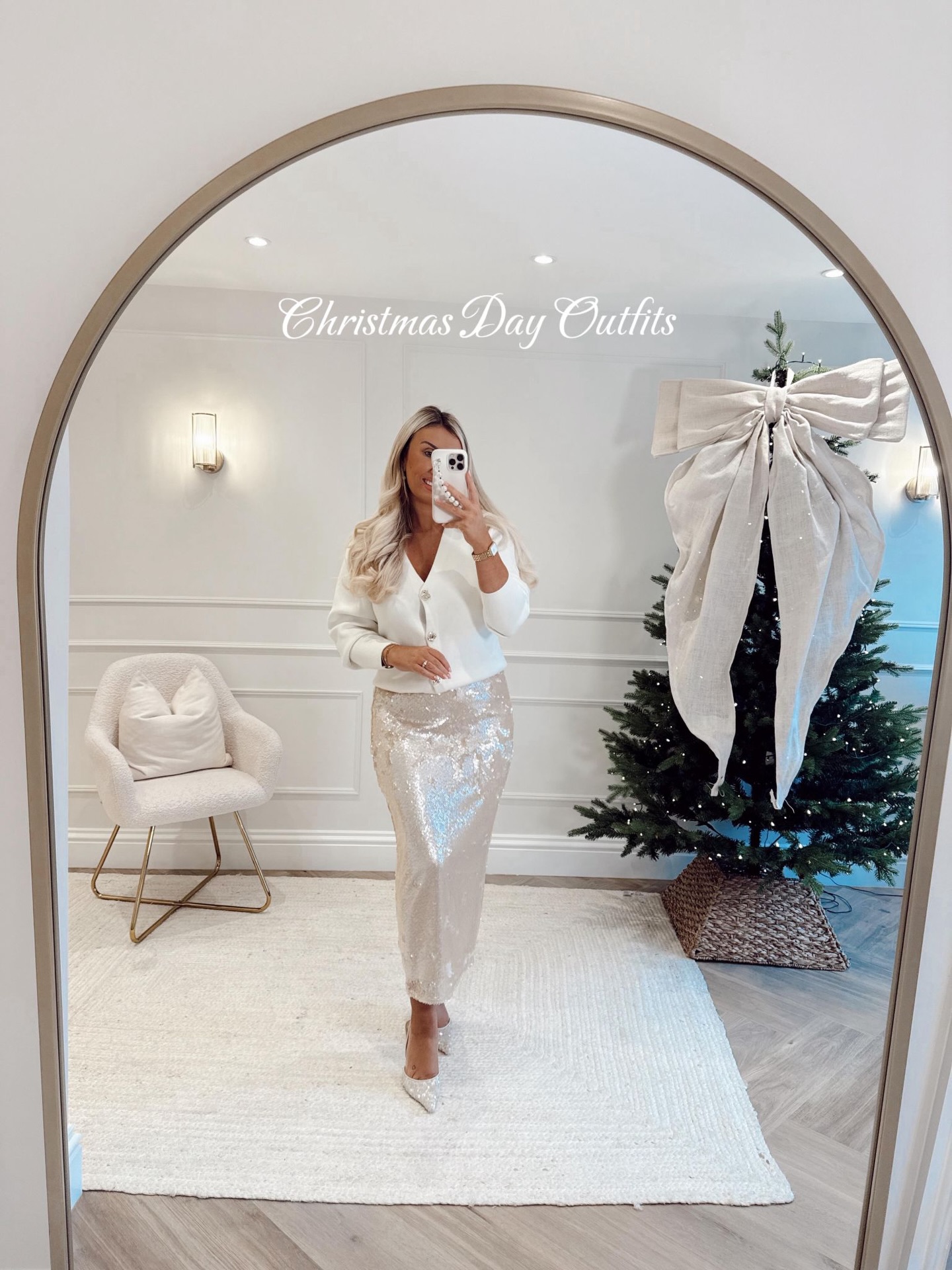 White button-front cardigan with silver sequin midi skirt and white heels for Christmas Eve dinner.