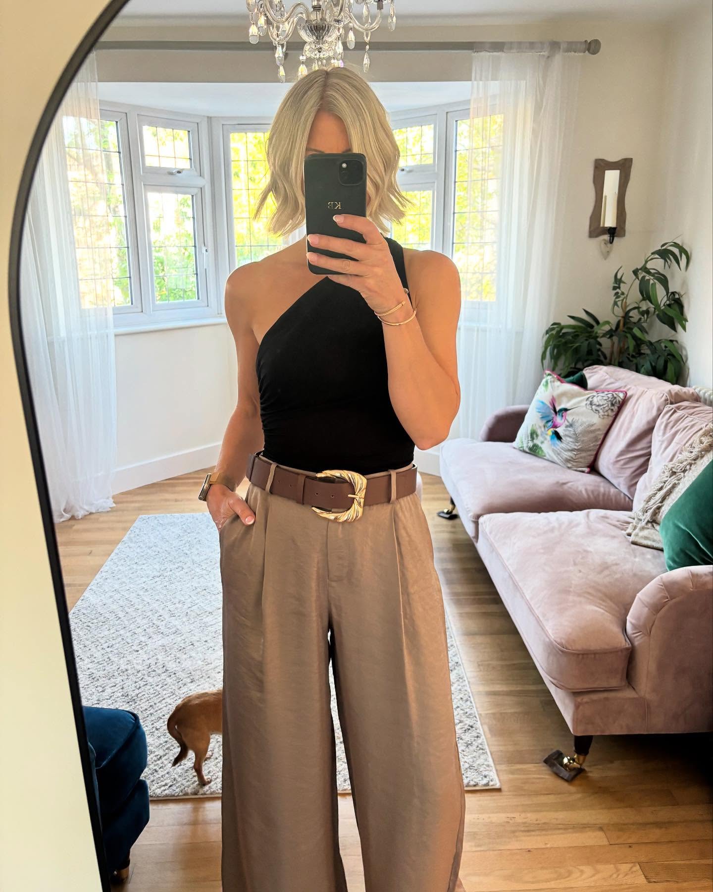 fitted black top with relaxed wide-leg trousers for women over 40