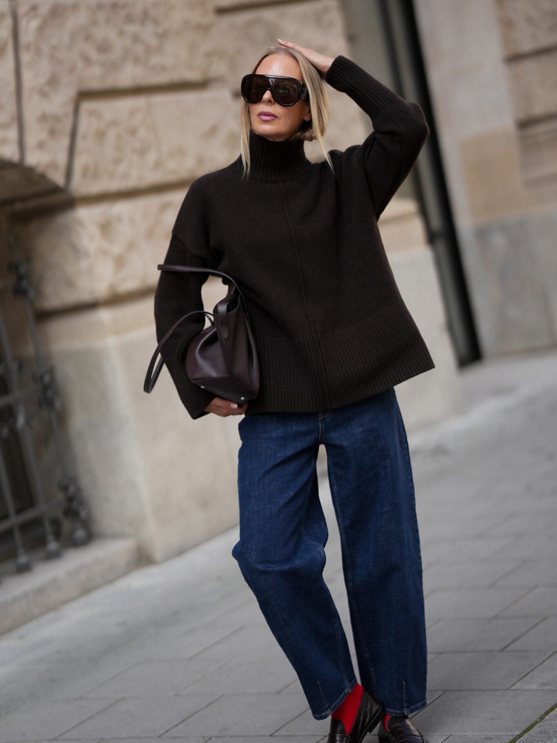 oversized black sweater with cropped jeans and ankle boots