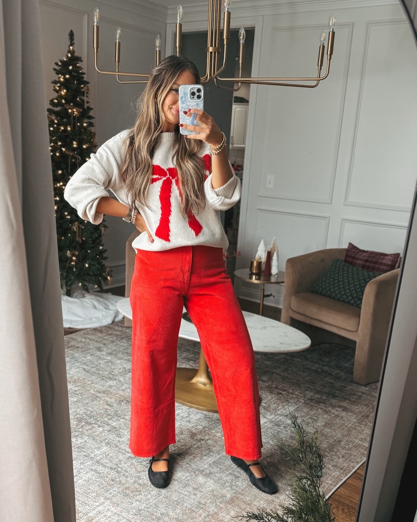Plus size Christmas sweater outfit with bow sweater and red wide-leg pants