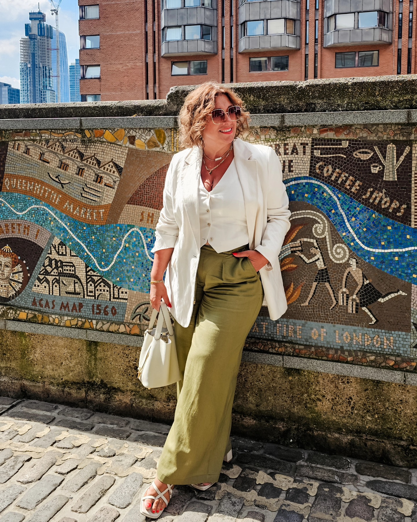 Cream blazer with olive relaxed trousers, a polished plus size outfit idea for women over 50.