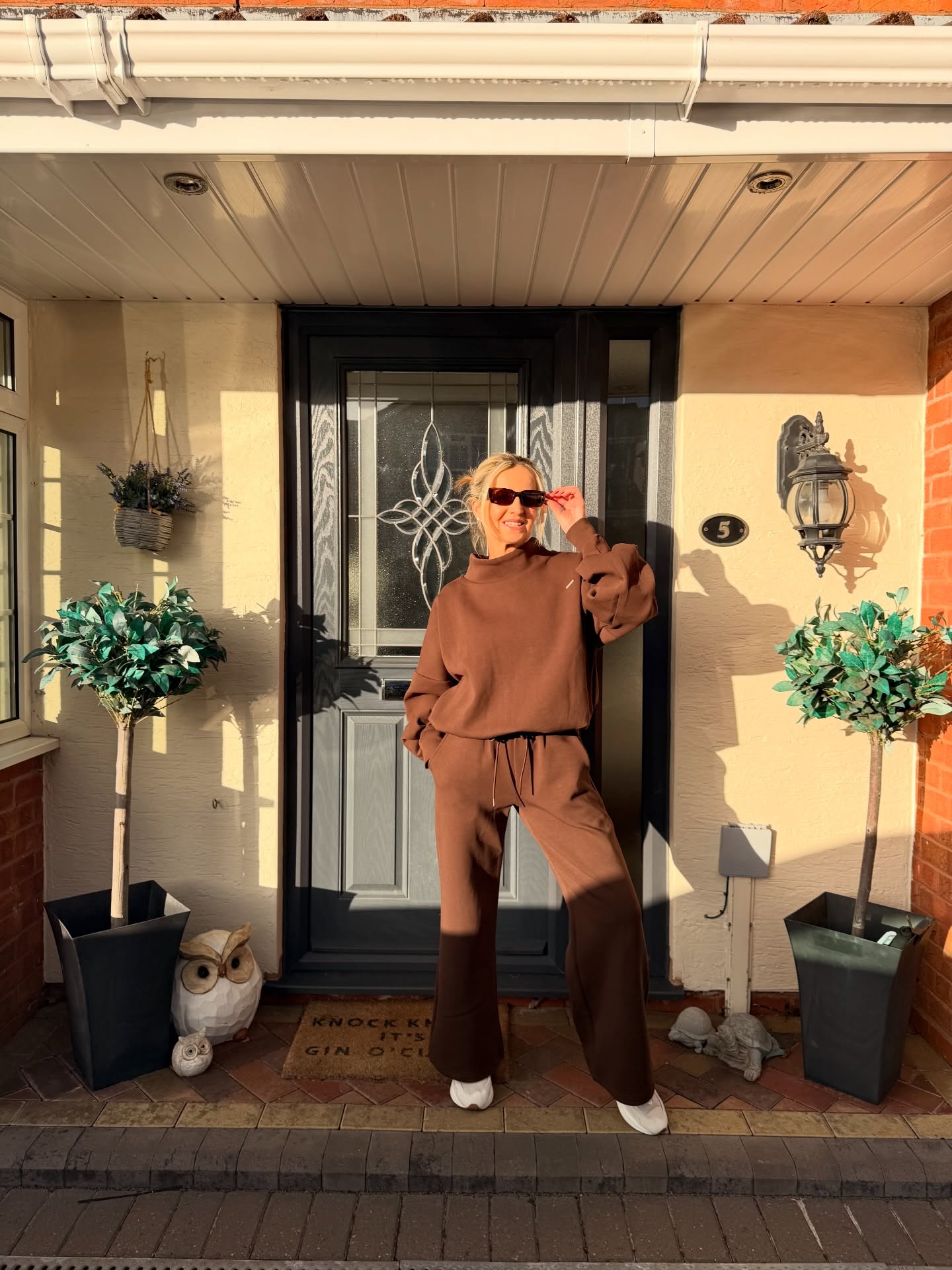Comfortable casual fall outfit for women over 40 with brown matching knit set and white sneakers
