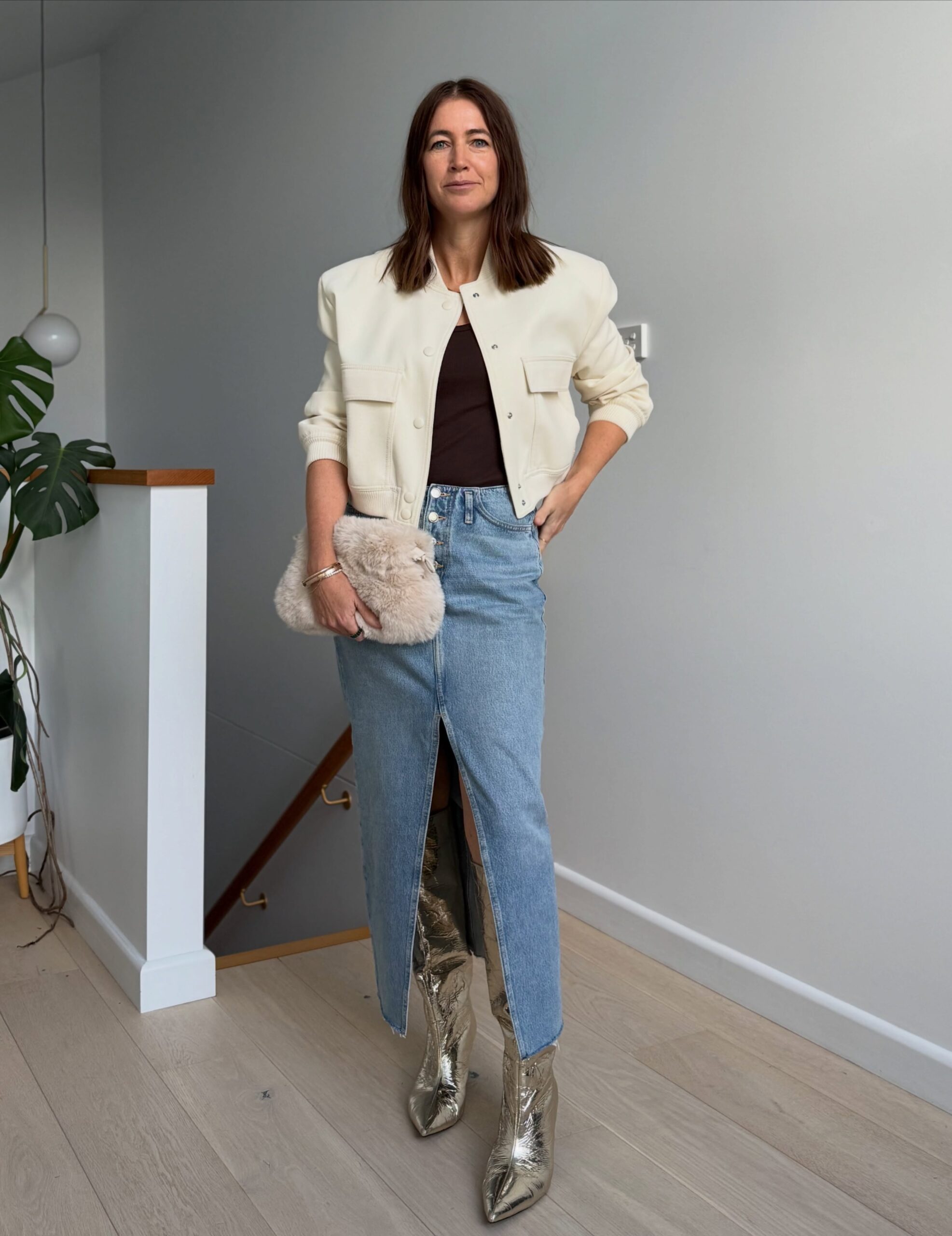 Casual fall skirt outfit for women over 40 with denim maxi skirt, cream jacket and ankle boots