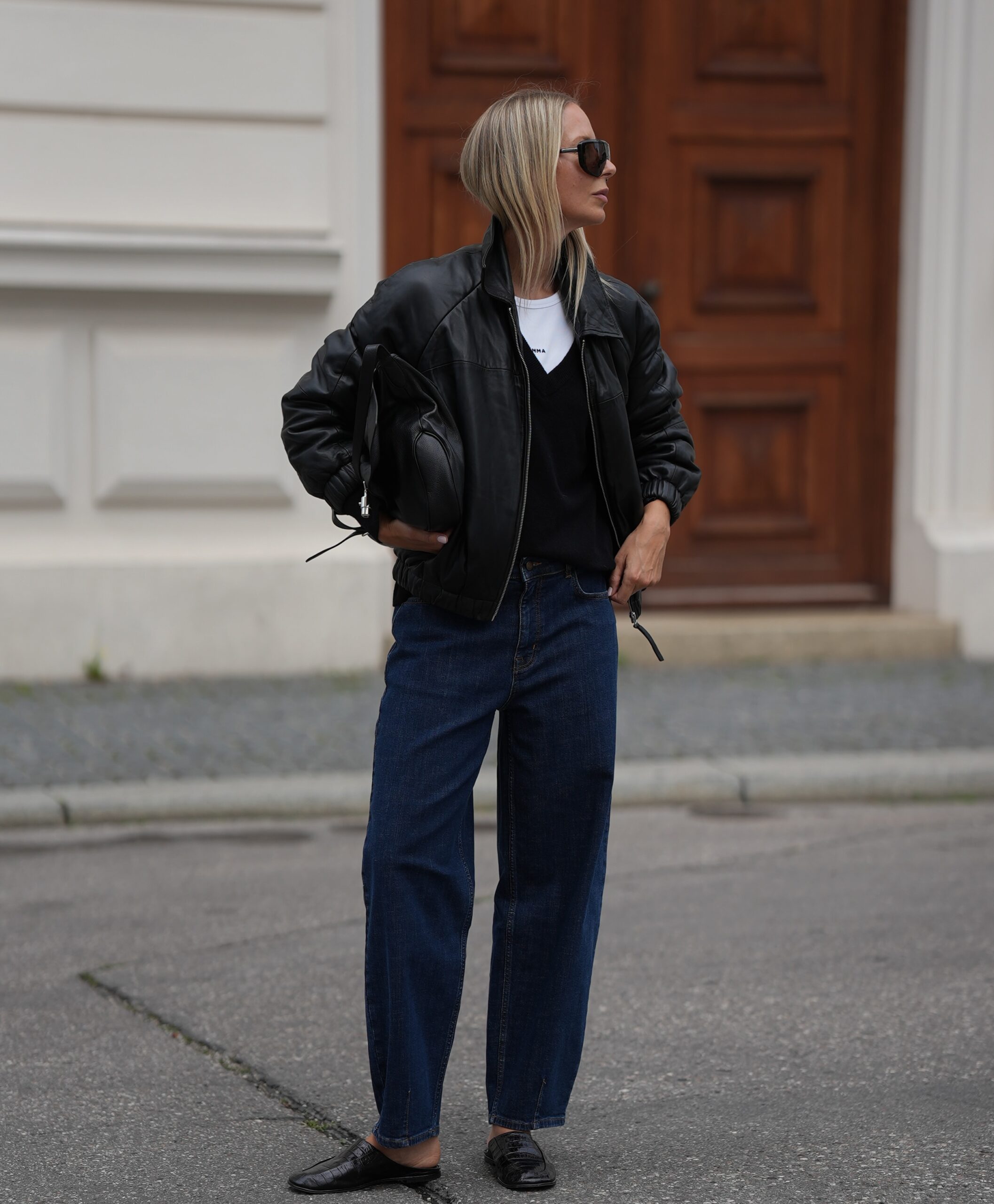 Easy fall outfit for women over 40 with dark jeans, black leather bomber jacket and loafers